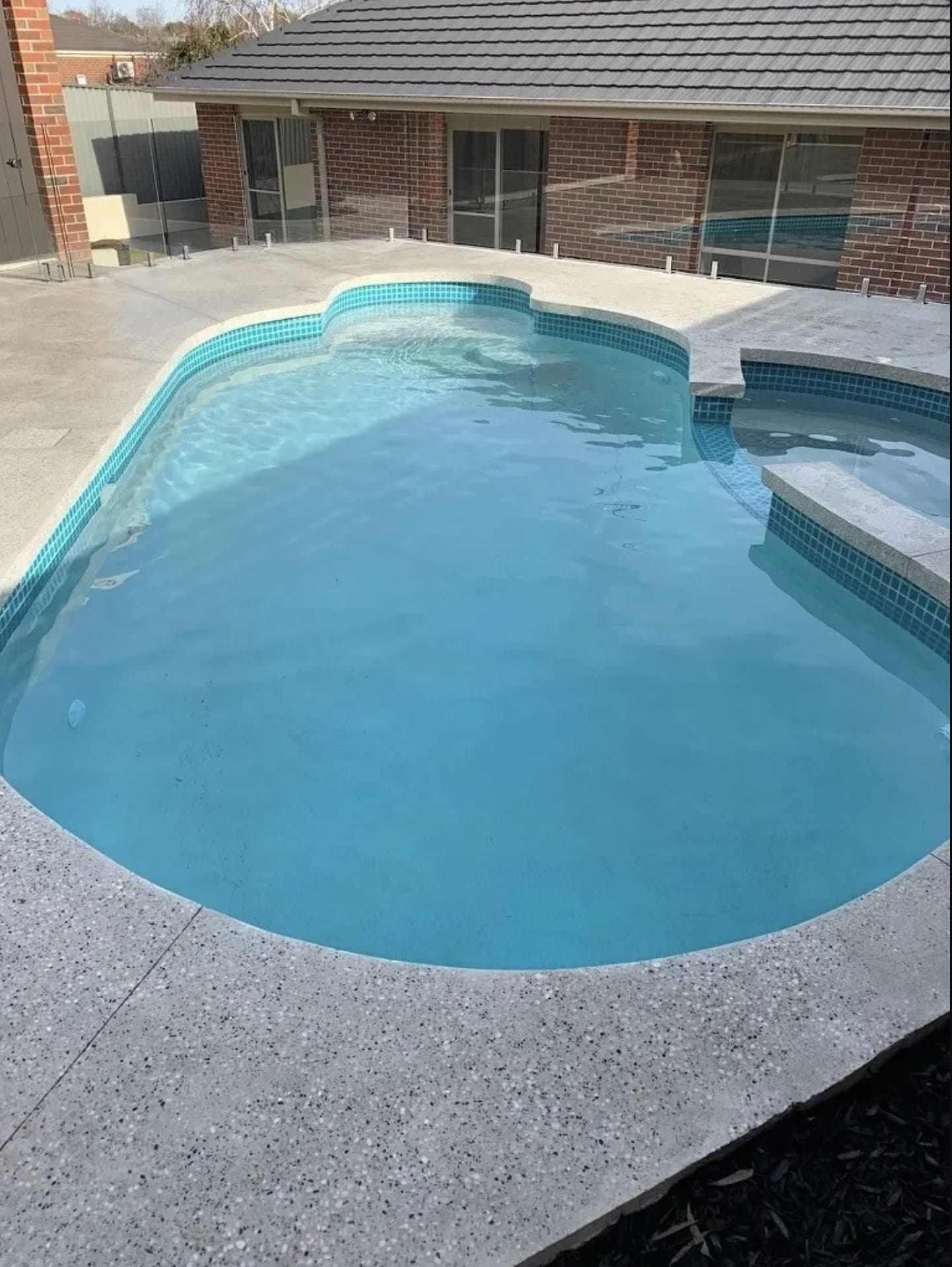 A finished freeform pool and spa renovation